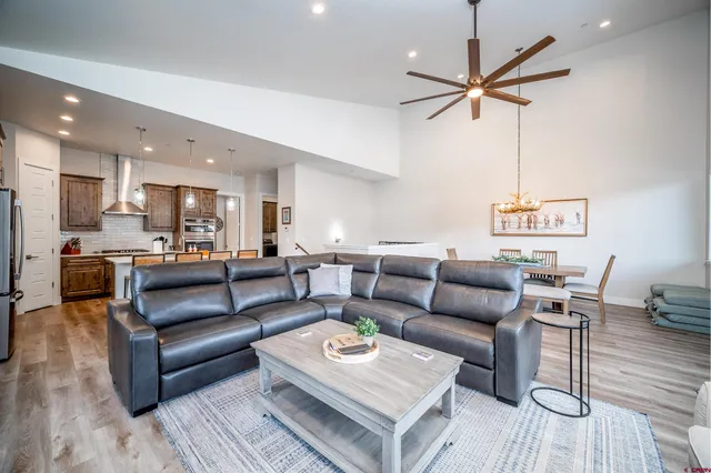 a living room with furniture and a view of kitchen