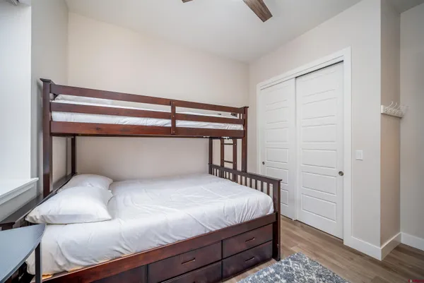 a bedroom with a large bed and a chandelier