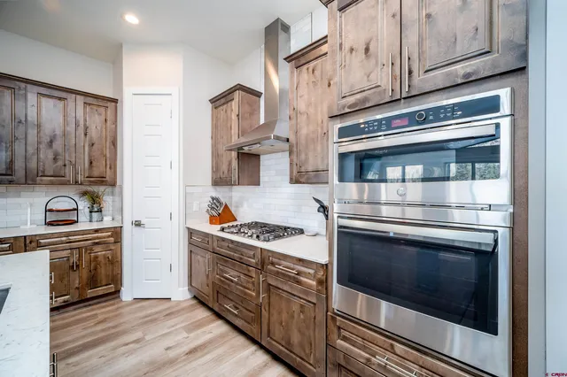 a kitchen with stainless steel appliances granite countertop a stove and a sink