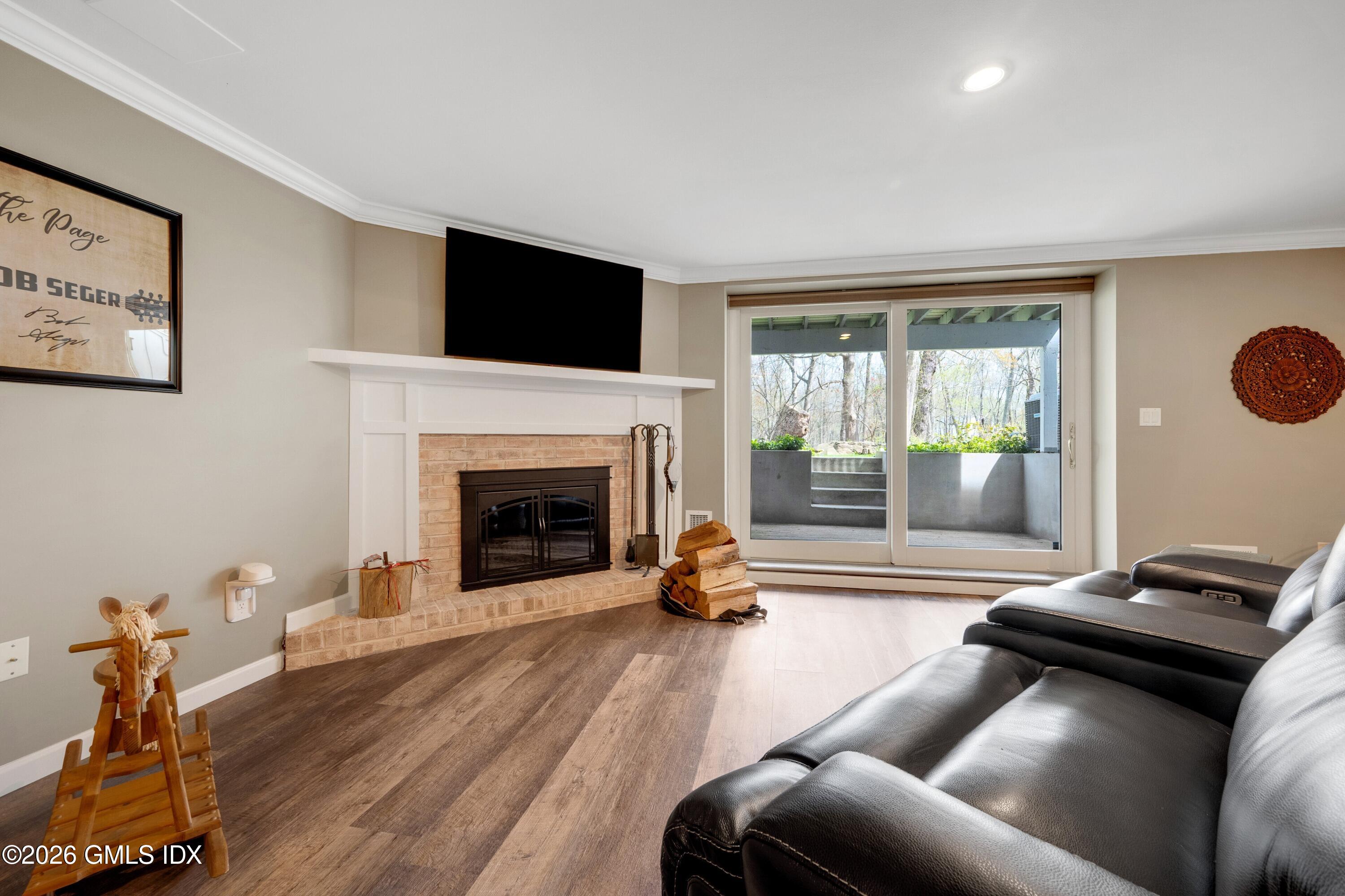 58 Stirrup Lane, Unit 58 Riverside, CT 06878 - Photo 15 of 23 a living room with furniture and a fireplace