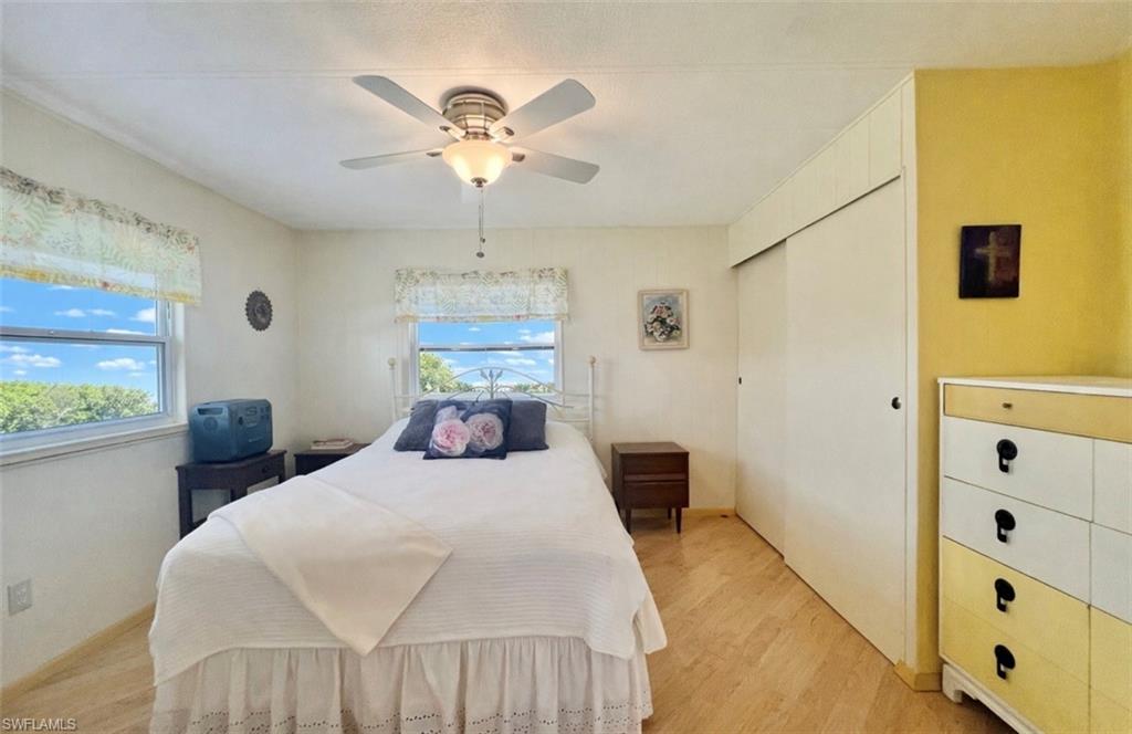 273 Cape Sable Drive Naples, FL 34104 - Photo 12 of 49 a bedroom with a bed and a chandelier