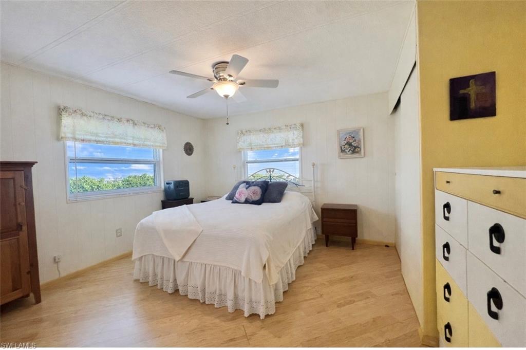 273 Cape Sable Drive Naples, FL 34104 - Photo 13 of 49 a bedroom with a bed and a window