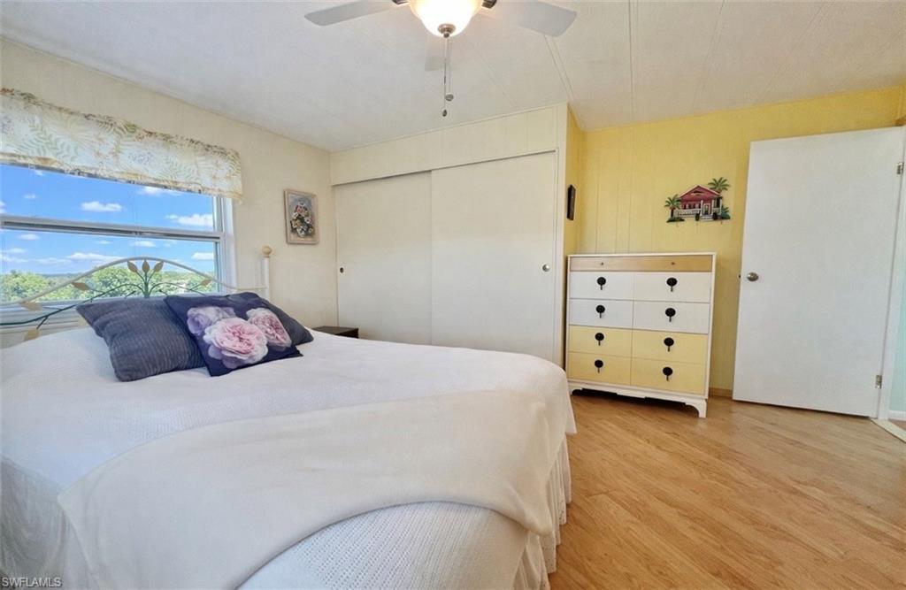 273 Cape Sable Drive Naples, FL 34104 - Photo 14 of 49 a bedroom with a bed and a dresser
