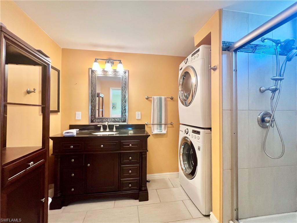 273 Cape Sable Drive Naples, FL 34104 - Photo 15 of 49 a bathroom with a granite countertop sink a mirror and a window