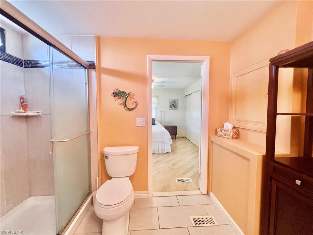 273 Cape Sable Drive Naples, FL 34104 - Photo 16 of 49 a bathroom with a toilet and a shower