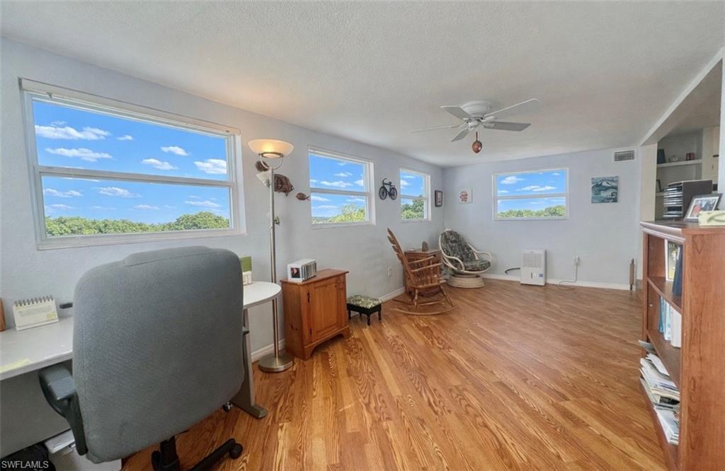 273 Cape Sable Drive Naples, FL 34104 - Photo 19 of 49 a workspace with furniture hardwood and a window