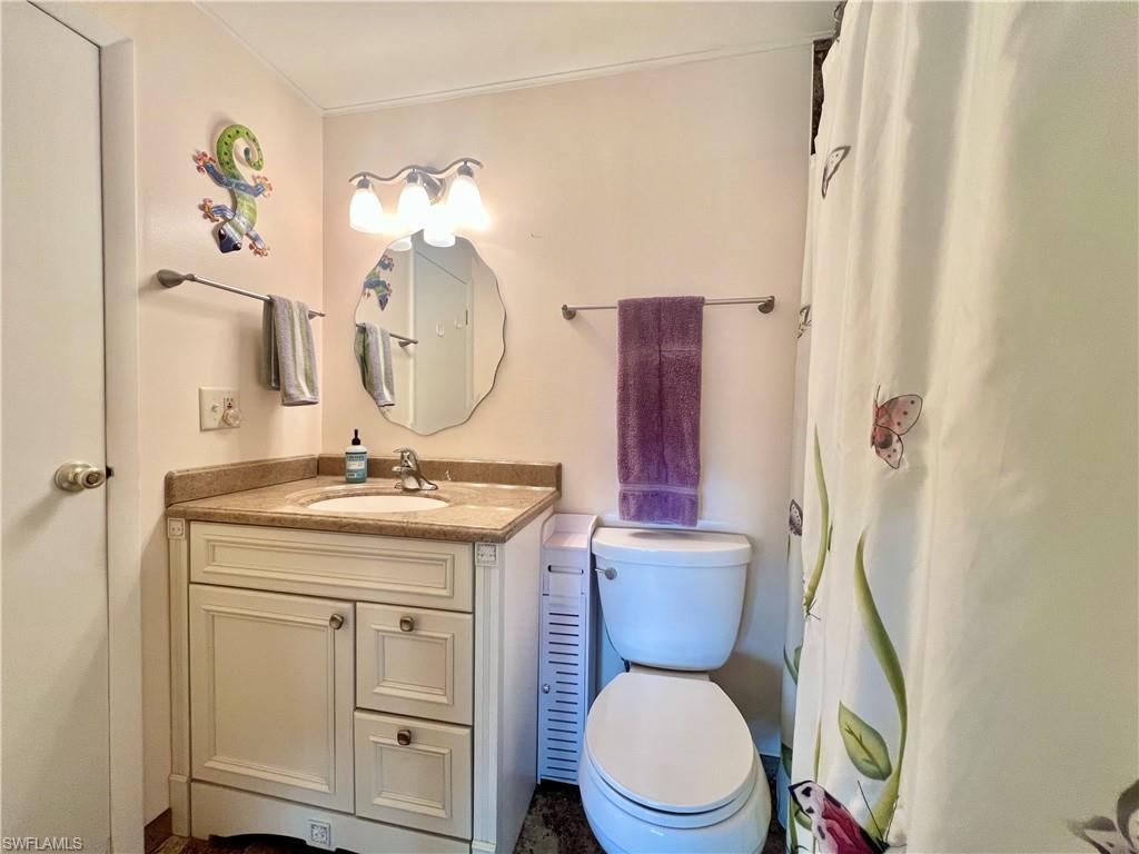 273 Cape Sable Drive Naples, FL 34104 - Photo 23 of 49 a bathroom with a toilet a sink and a mirror