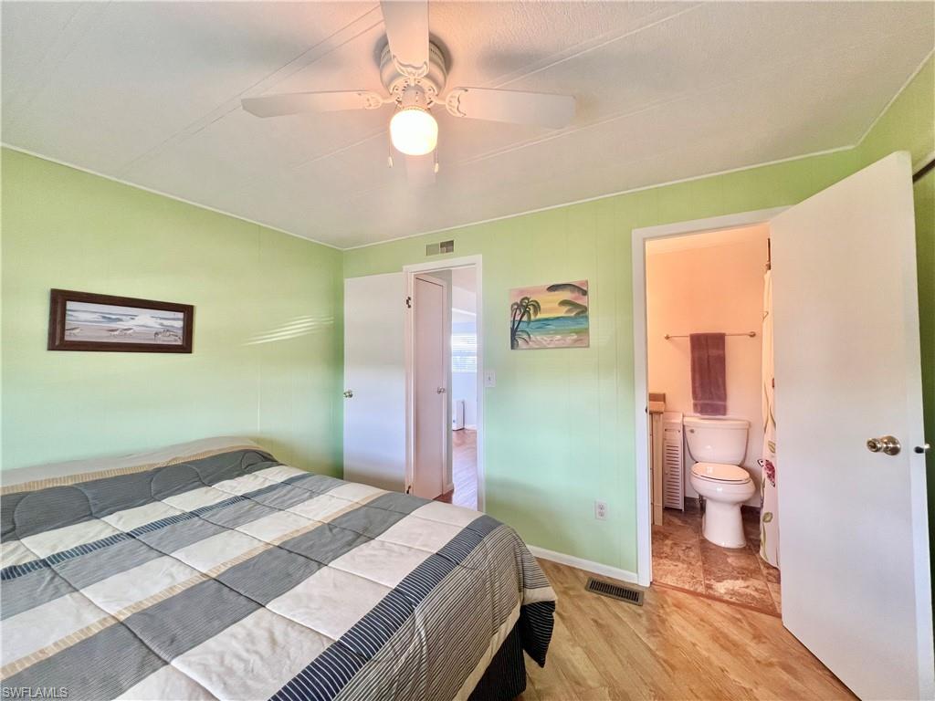 273 Cape Sable Drive Naples, FL 34104 - Photo 24 of 49 a bedroom with a bed and a chandelier