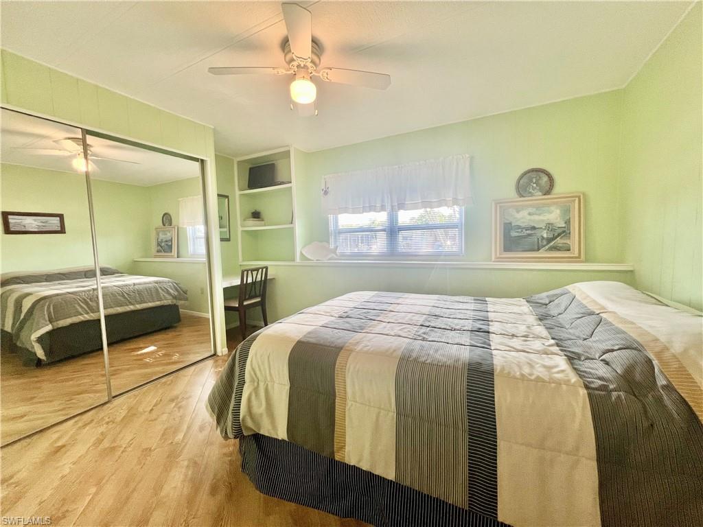 273 Cape Sable Drive Naples, FL 34104 - Photo 25 of 49 a bedroom with a large bed and a chandelier