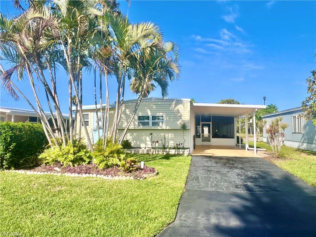 273 Cape Sable Drive Naples, FL 34104 - Photo 3 of 49 a front view of a house with a yard