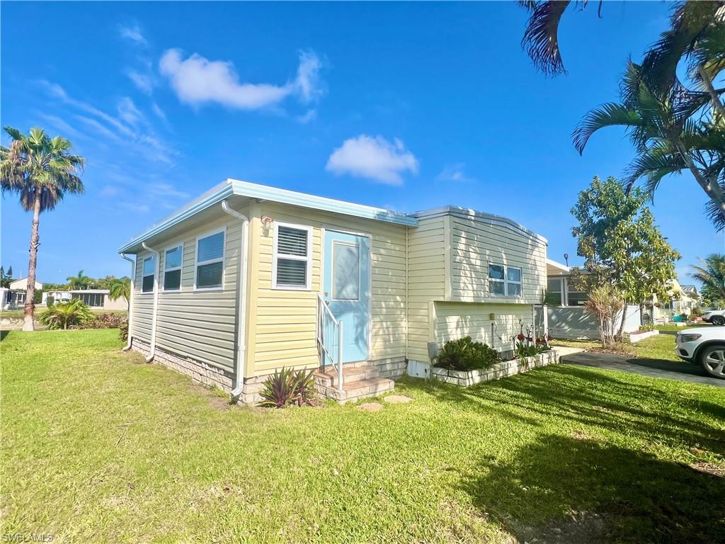 273 Cape Sable Drive Naples, FL 34104 - Photo 38 of 49 a front view of a house with a yard