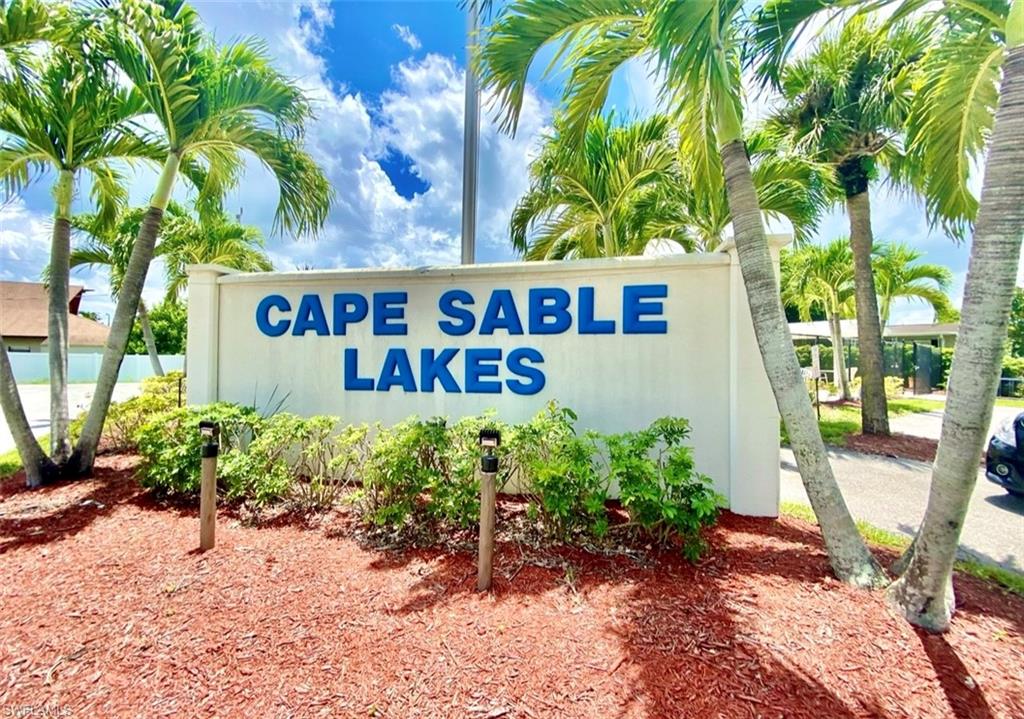 273 Cape Sable Drive Naples, FL 34104 - Photo 45 of 49 a sign that is in front of flowers