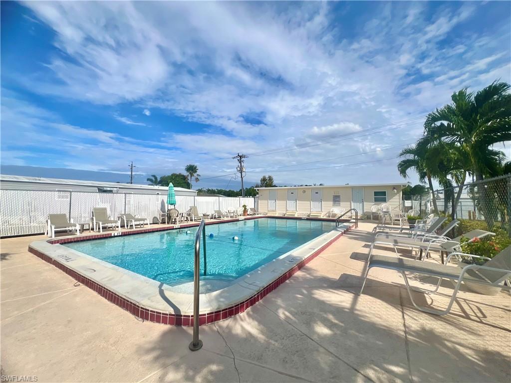 273 Cape Sable Drive Naples, FL 34104 - Photo 46 of 49 a view of a swimming pool with a lounge chairs