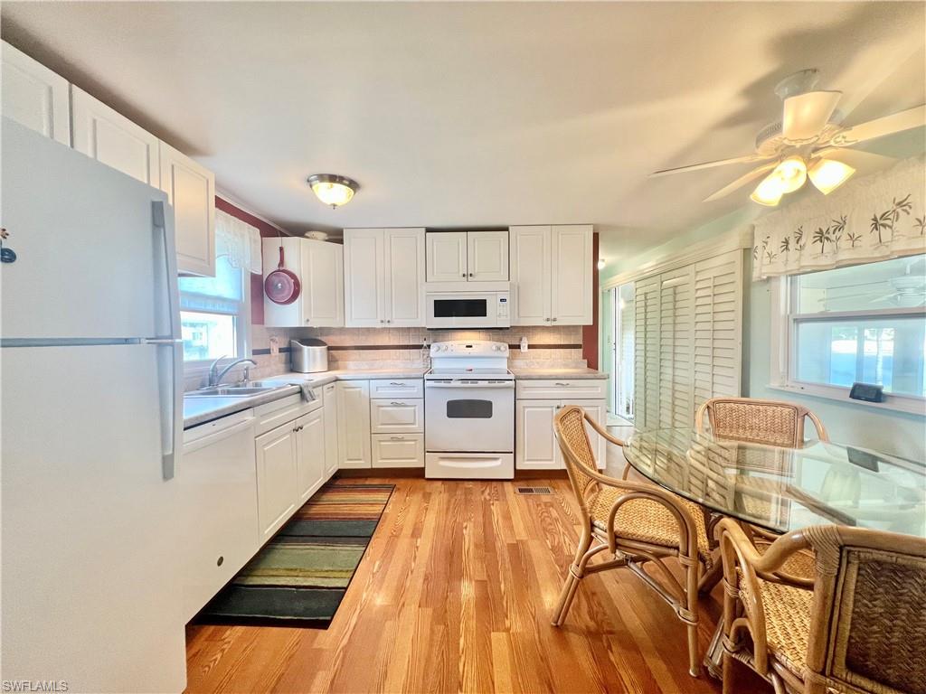 273 Cape Sable Drive Naples, FL 34104 - Photo 7 of 49 a kitchen with stainless steel appliances a stove a sink cabinets and a refrigerator