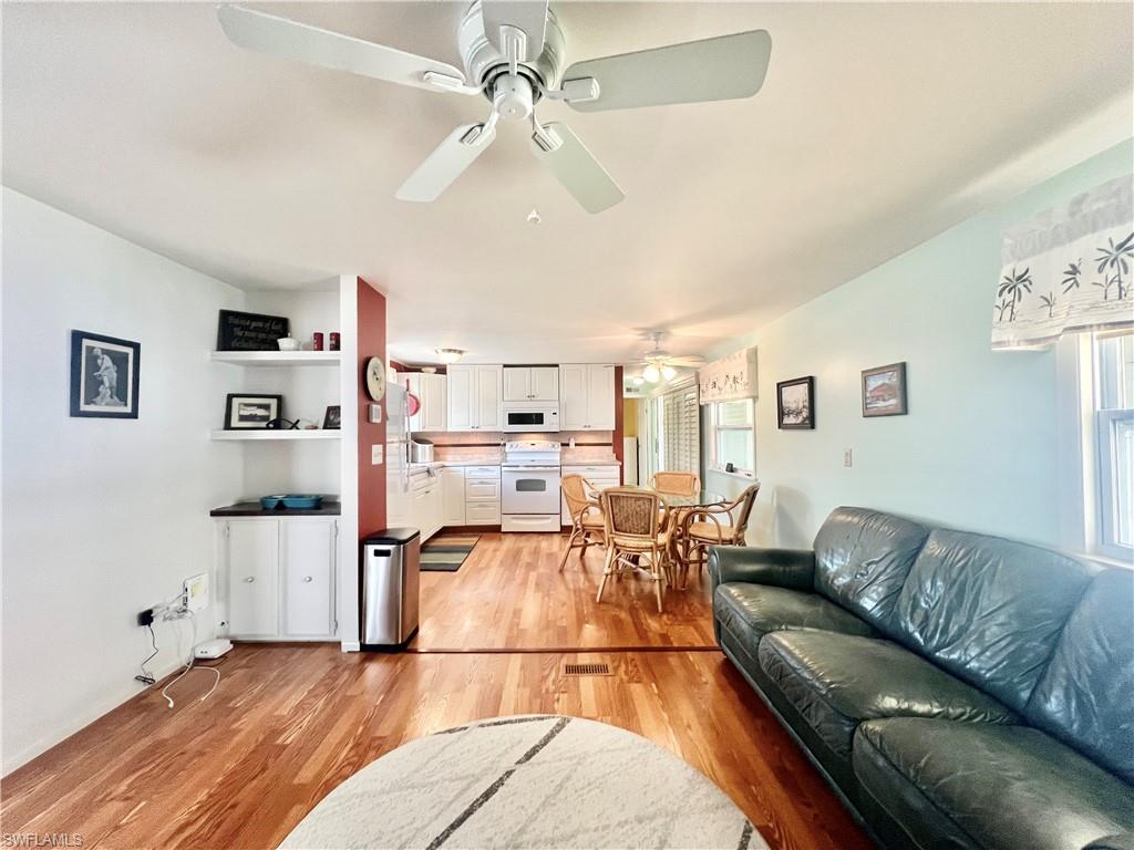 273 Cape Sable Drive Naples, FL 34104 - Photo 9 of 49 a living room with furniture and a wooden floor