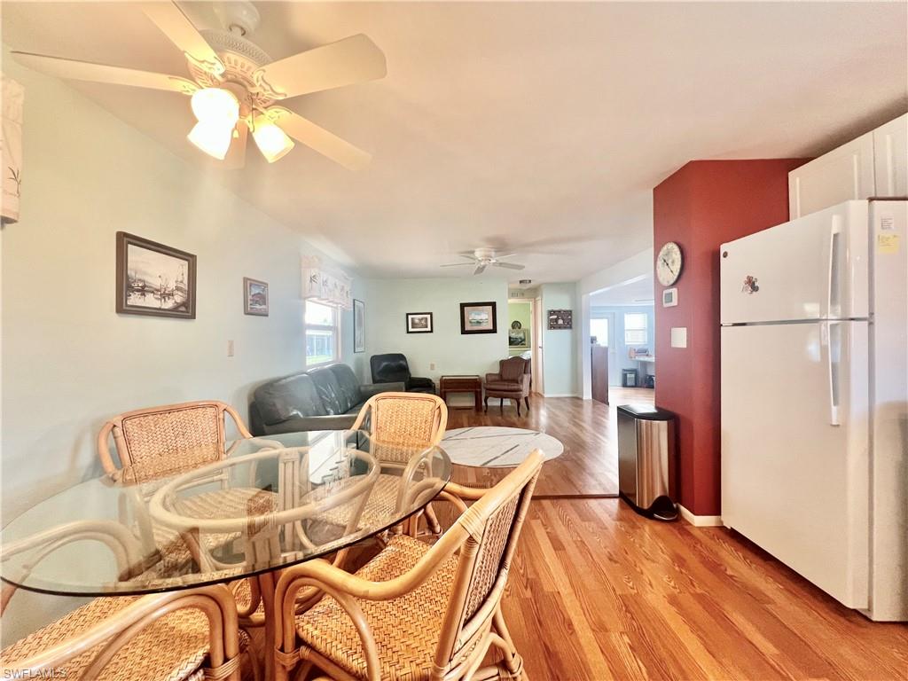 273 Cape Sable Drive Naples, FL 34104 - Photo 10 of 49 a dining room with furniture and a chandelier