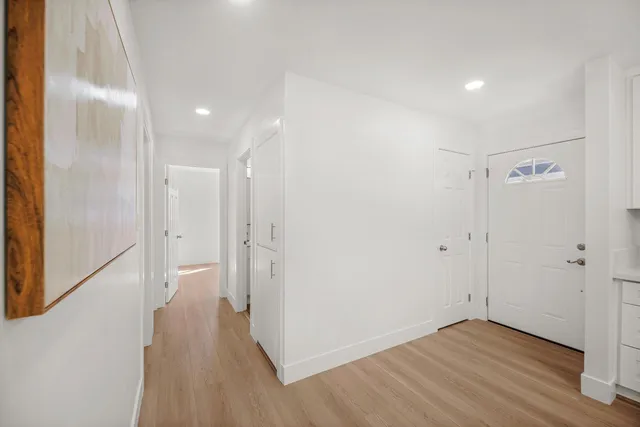 a view of a hallway with wooden floor