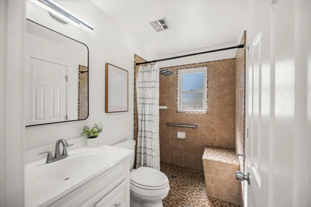 a bathroom with a sink toilet and shower