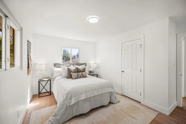 a bedroom with a bed and a window