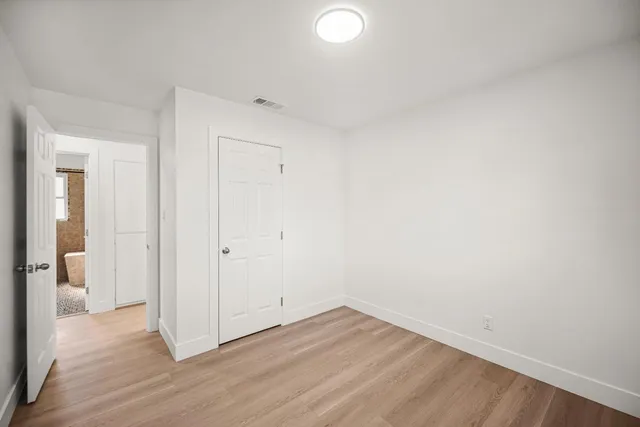 a view of a room with wooden floor