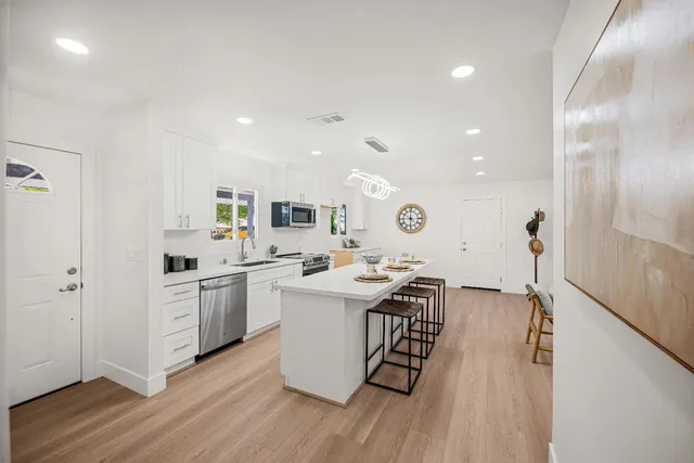 a kitchen with a sink stainless steel appliances and cabinets