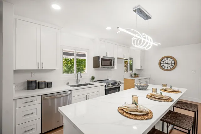 a kitchen with a dining table and chairs in it
