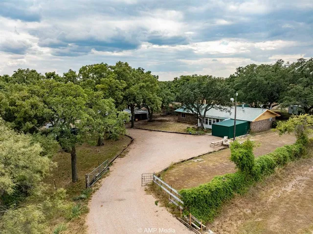 a view of a street with next to a yard