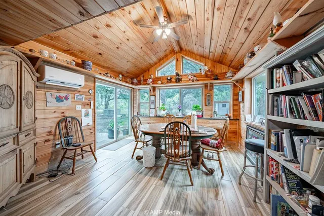 a dining room with furniture and a book shelf