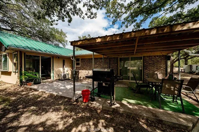 a view of a house with backyard sitting area and garden