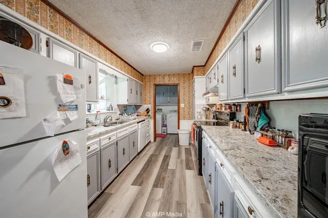 a kitchen with stainless steel appliances granite countertop a sink stove and cabinets