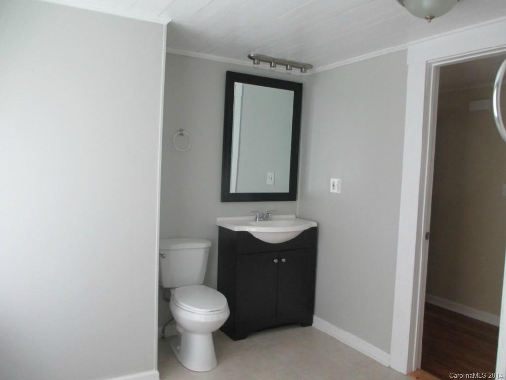 4091 Flat Creek Road Lancaster, SC 29720 - Photo 11 of 19 a bathroom with a toilet sink vanity and mirror