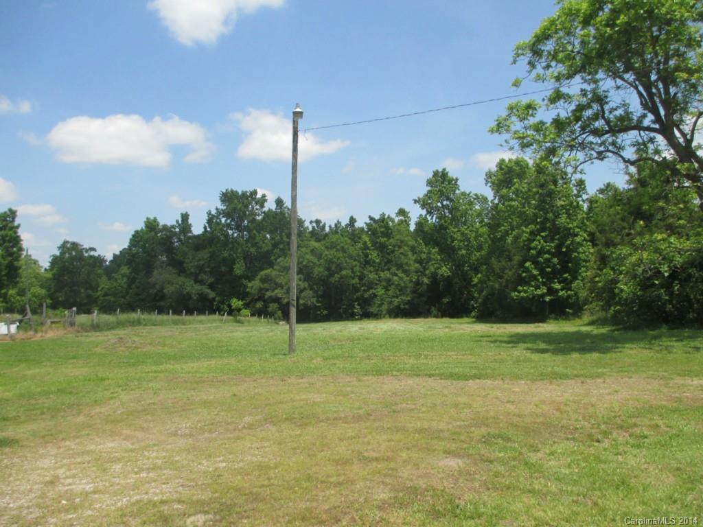 4091 Flat Creek Road Lancaster, SC 29720 - Photo 19 of 19 a view of a grassy field with trees in the background