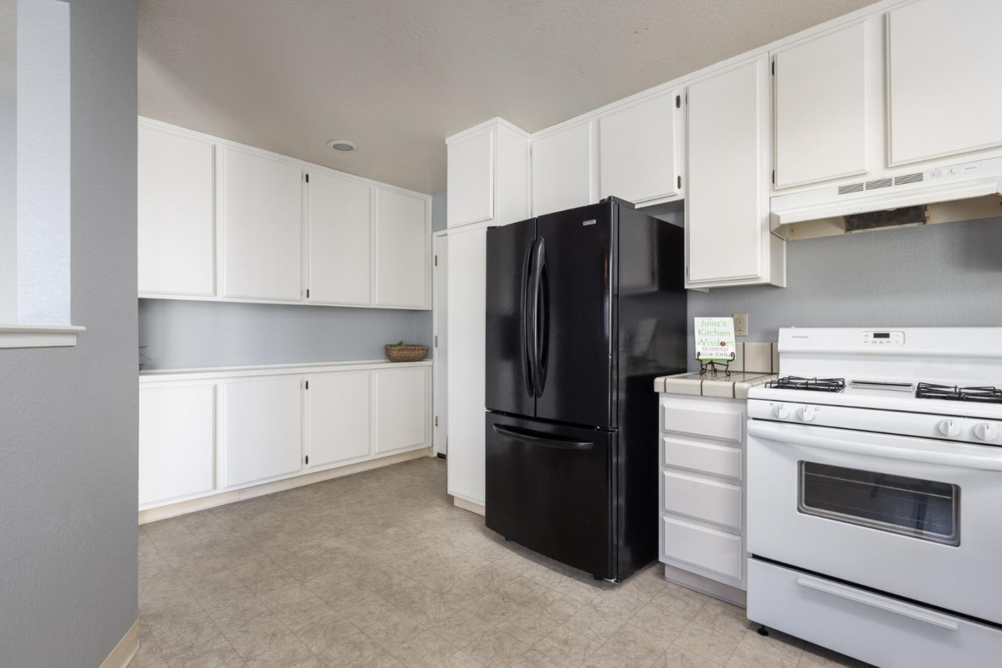 1061 Olympic Lane Seaside, CA 93955 - Photo 11 of 24 a kitchen with refrigerator stove and cabinets