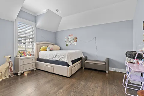 a bedroom with a bed and a desk