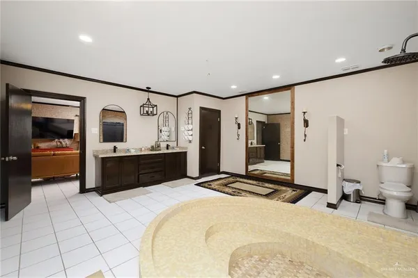 a bedroom with a bed and a large mirror