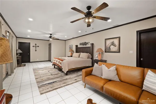 a bedroom with a large bed couch and a window