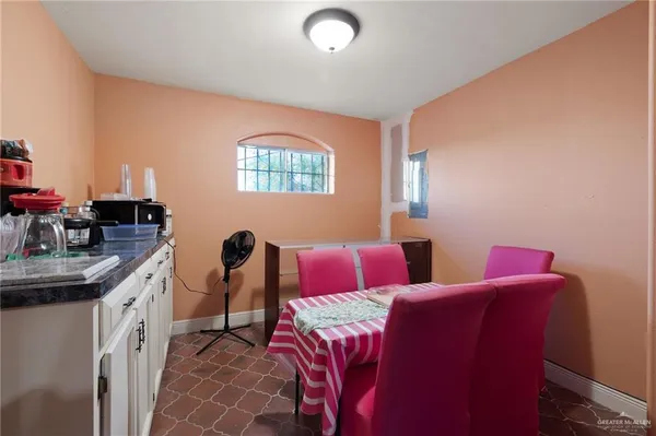 a bedroom with two beds and a desk