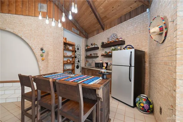 a view of a dining room with furniture and a kitchen