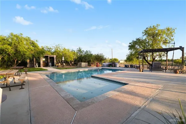 a view of swimming pool with outdoor seating and city view