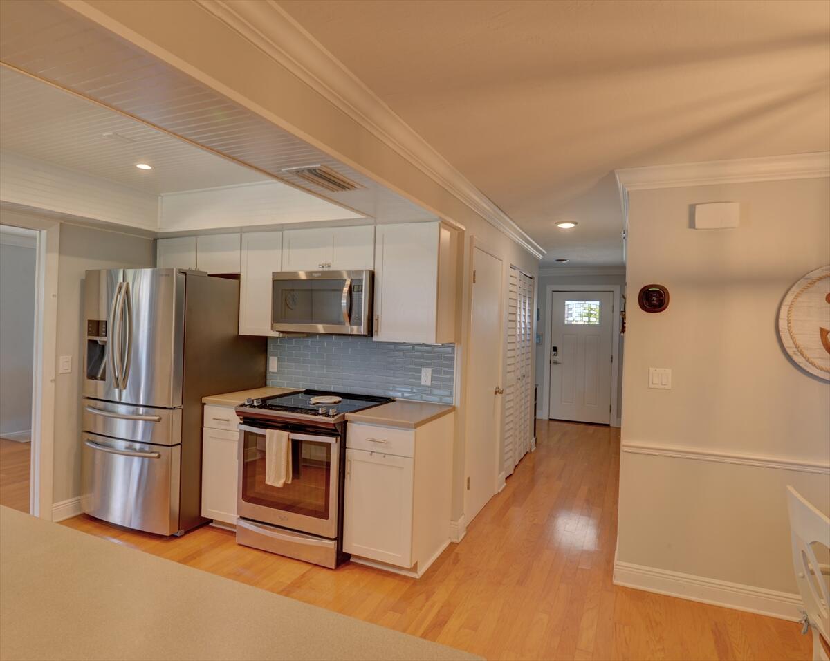365 Kingston Road Satellite Beach, FL 32937 - Photo 11 of 31 a kitchen with stainless steel appliances a stove a refrigerator and a refrigerator
