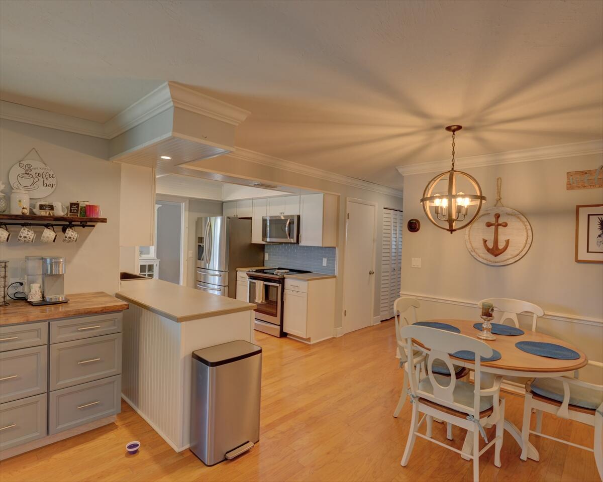 365 Kingston Road Satellite Beach, FL 32937 - Photo 12 of 31 a dining room with wooden floor and stainless steel appliances