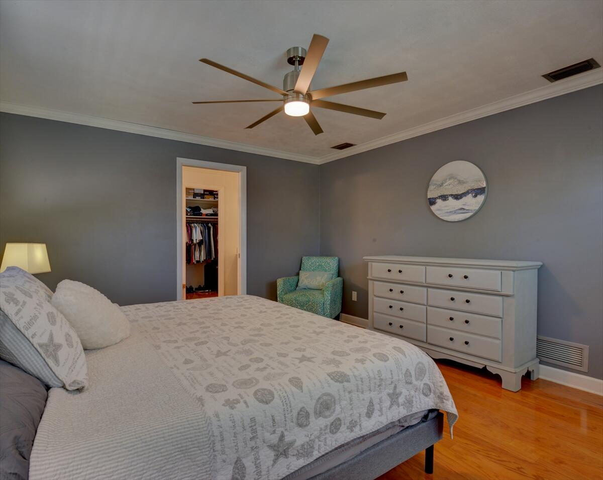 365 Kingston Road Satellite Beach, FL 32937 - Photo 18 of 31 a bedroom with a bed and a chandelier