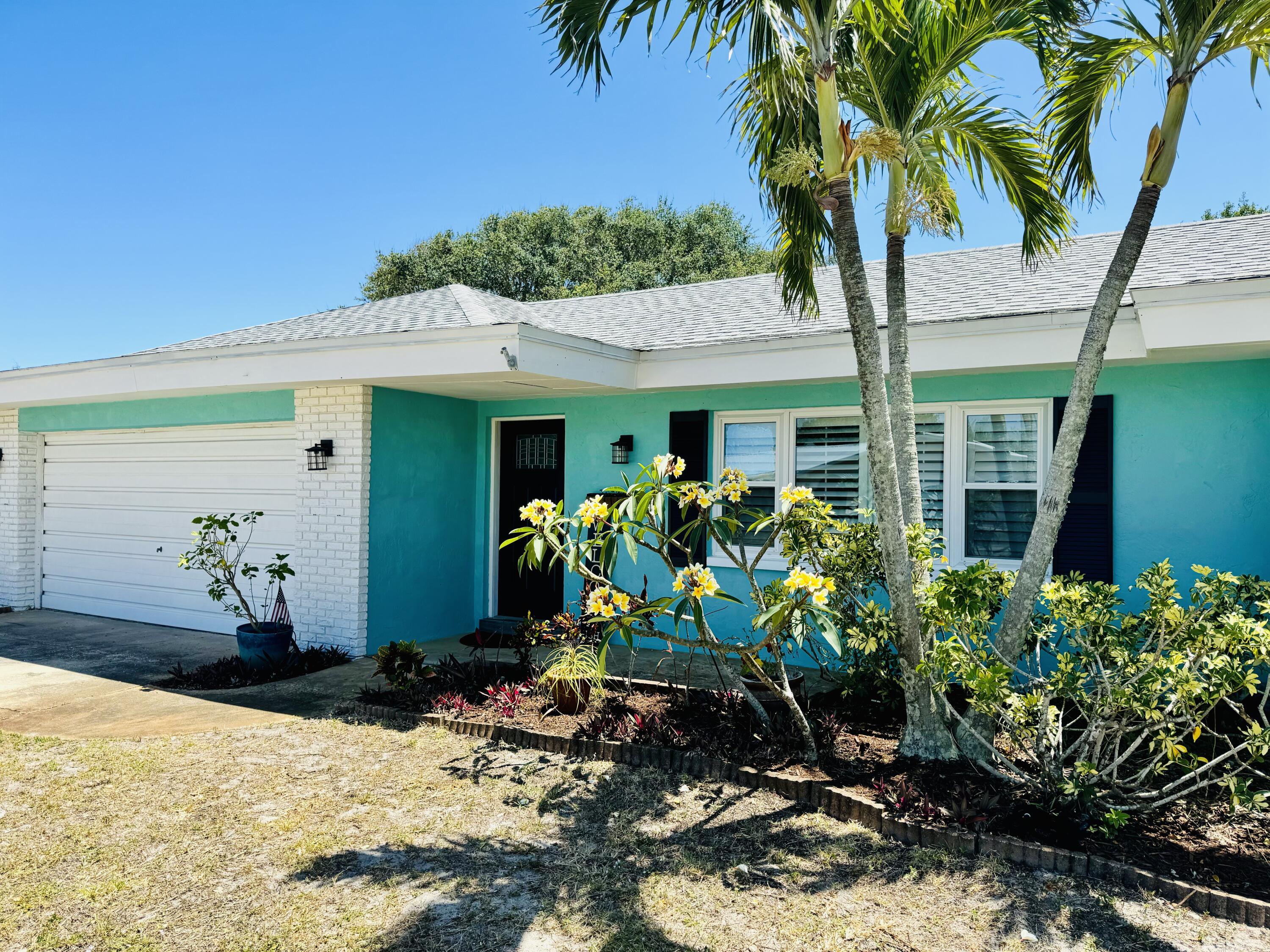 365 Kingston Road Satellite Beach, FL 32937 - Photo 2 of 31 a front view of a house with garden