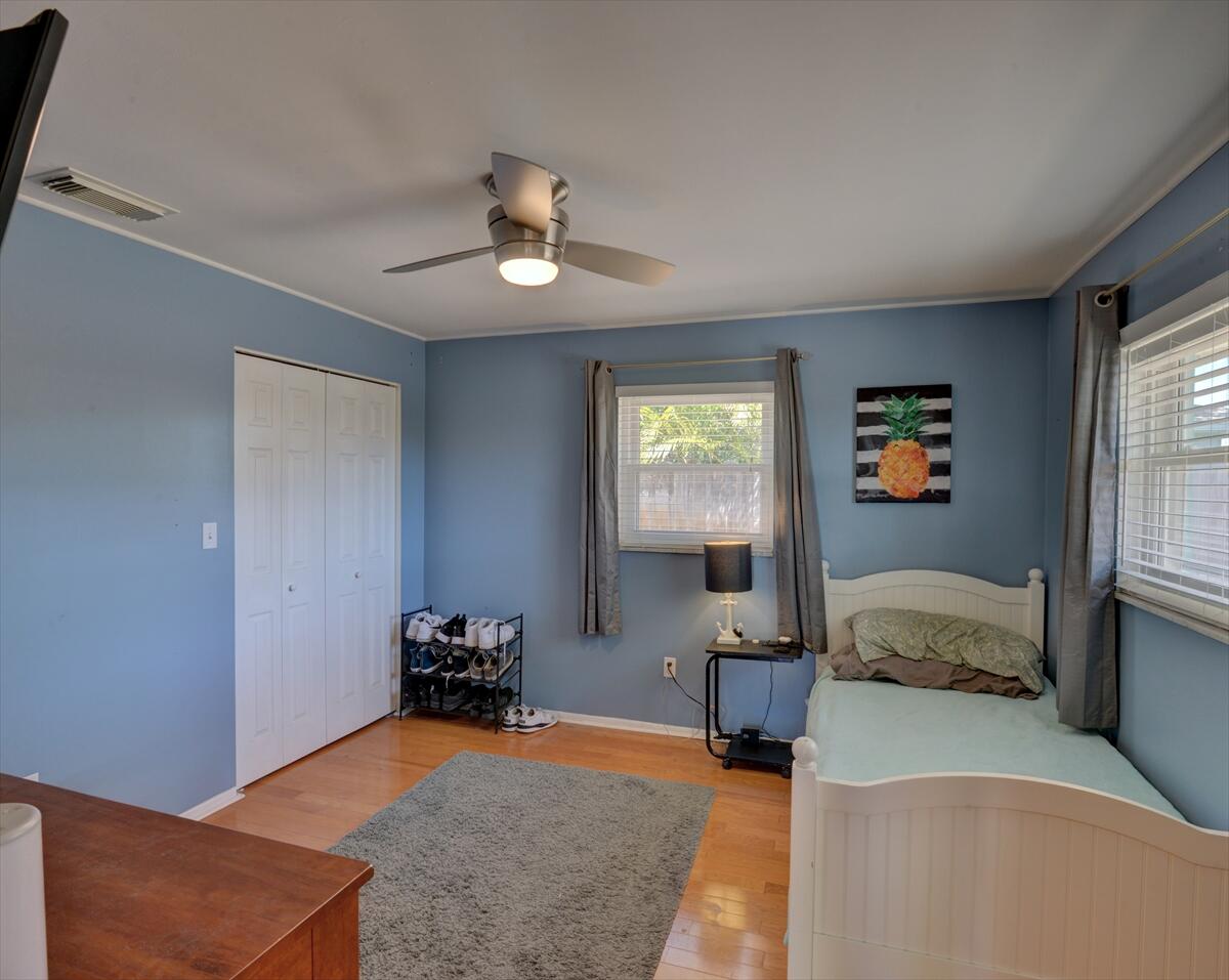 365 Kingston Road Satellite Beach, FL 32937 - Photo 25 of 31 a bedroom with a bed and wooden floor
