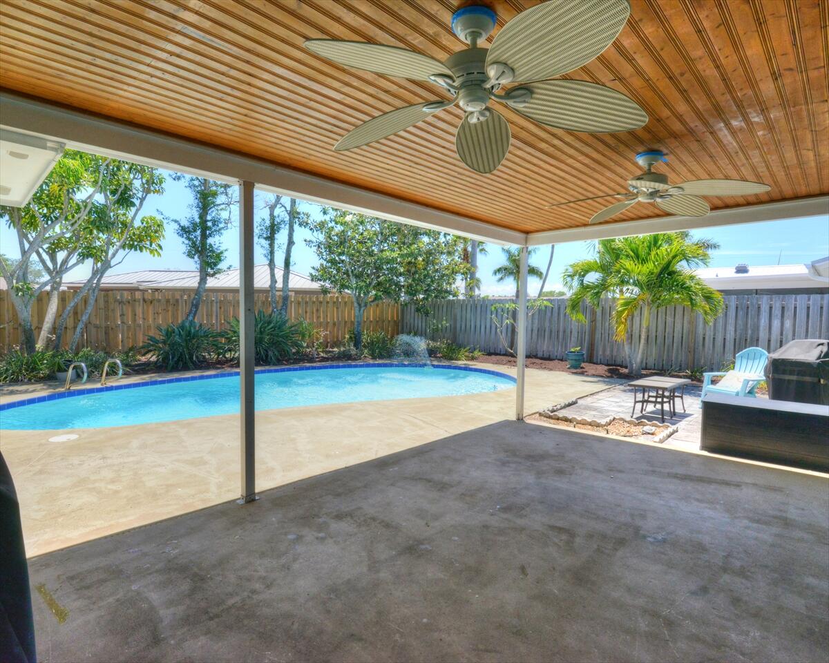 365 Kingston Road Satellite Beach, FL 32937 - Photo 27 of 31 a view of a patio with a table chairs and a swimming pool