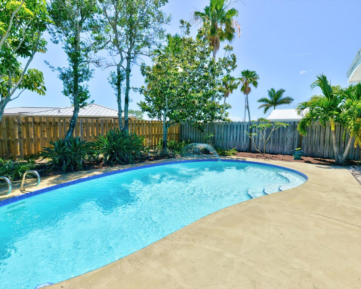 365 Kingston Road Satellite Beach, FL 32937 - Photo 28 of 31 a view of a backyard with a small swimming pool