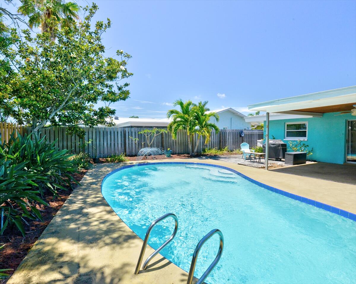 365 Kingston Road Satellite Beach, FL 32937 - Photo 29 of 31 a swimming pool with outdoor seating and yard