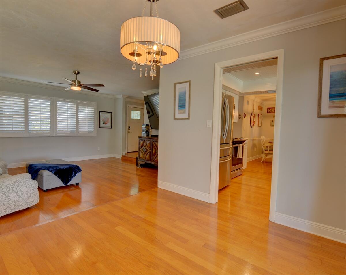 365 Kingston Road Satellite Beach, FL 32937 - Photo 8 of 31 a view of a livingroom with a furniture wooden floor kitchen chandelier and a refrigerator
