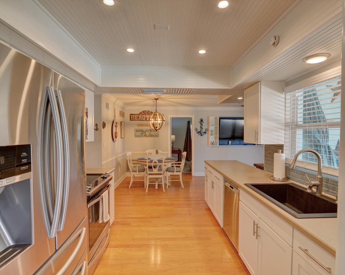 365 Kingston Road Satellite Beach, FL 32937 - Photo 10 of 31 a kitchen with granite countertop a sink appliances and cabinets