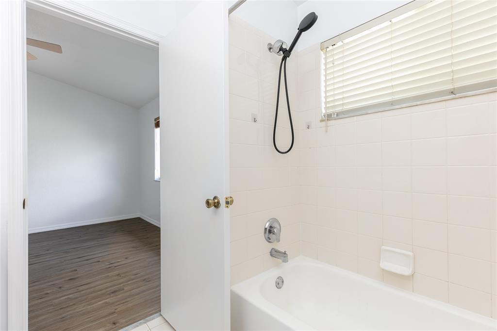 159 Hidden Ct Road, Unit I49 Hollywood, FL 33023 - Photo 13 of 21 a bathroom with a white bath tub a sink and a shower